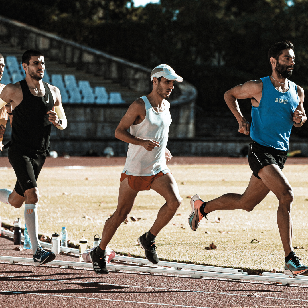 Runners racing on an athletics track